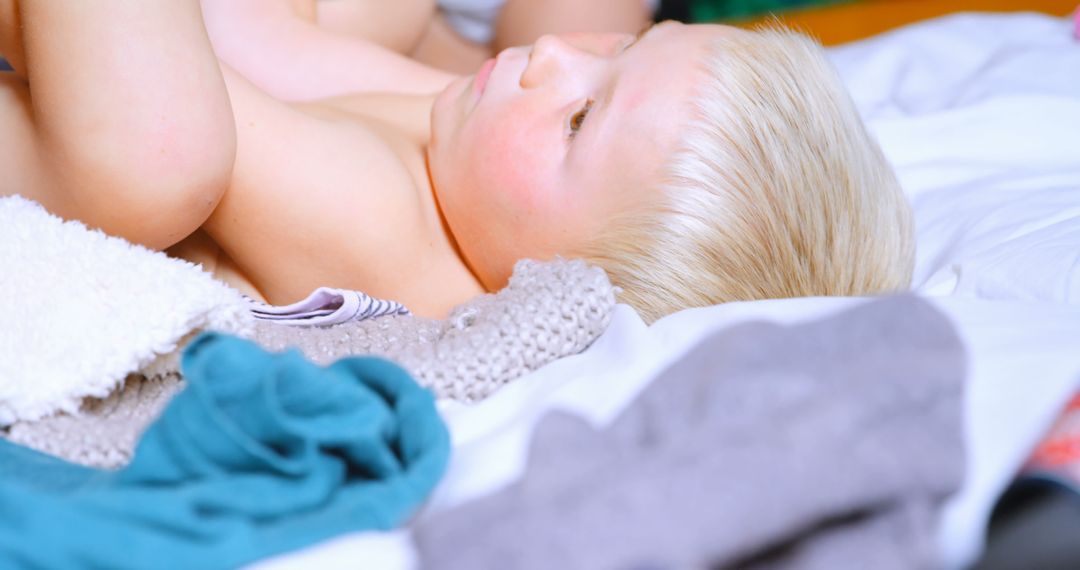 Blonde Child Relaxing on Bed in Cozy Home Environment