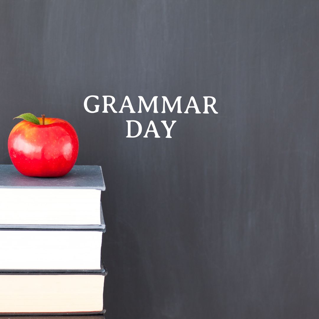 Grammar Day Concept with Books and Apple on Chalkboard