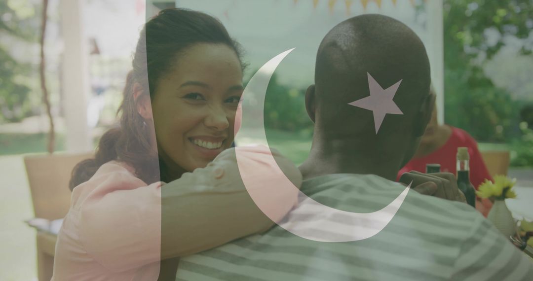 Hugging couple smiling at backyard gathering with crescent and star flag overlay