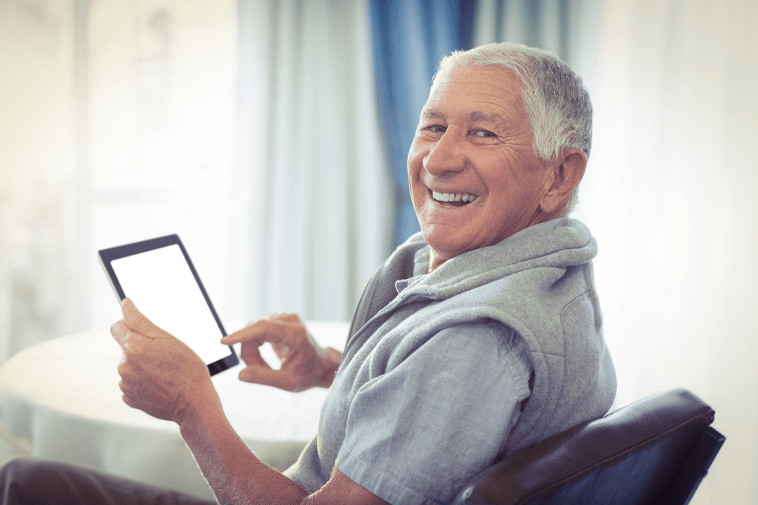 Senior Man Happily Using Transparent Tablet at Home