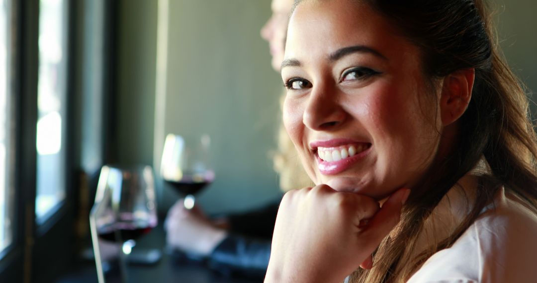 Young Woman Smiling and Drinking Red Wine at Restaurant - Free Images, Stock Photos and Pictures on Pikwizard.com