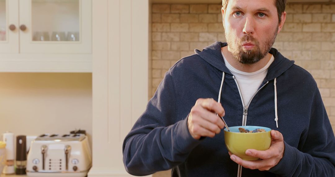 Man Eating Cereal in Kitchen during Morning - Free Images, Stock Photos and Pictures on Pikwizard.com