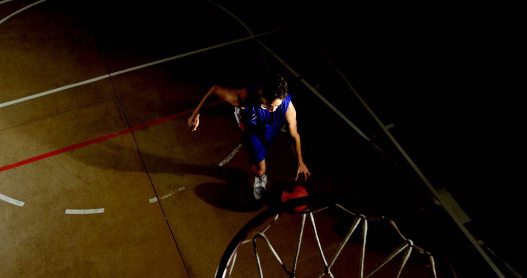 Basketball Player Dunking Under Basketball Hoop in Gymnasium - Free Images, Stock Photos and Pictures on Pikwizard.com