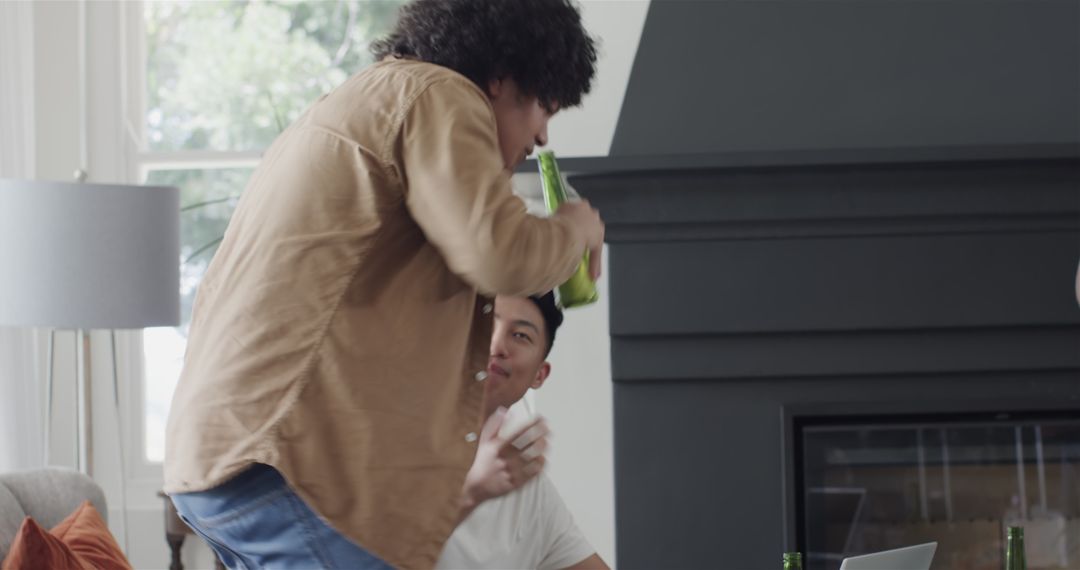 Friends Laughing and Celebrating with Drinks at Home