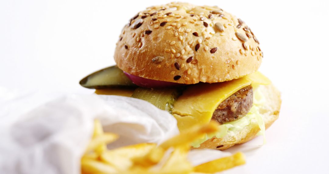 Close-Up of a Delicious Cheeseburger with Fries on White Background - Free Images, Stock Photos and Pictures on Pikwizard.com