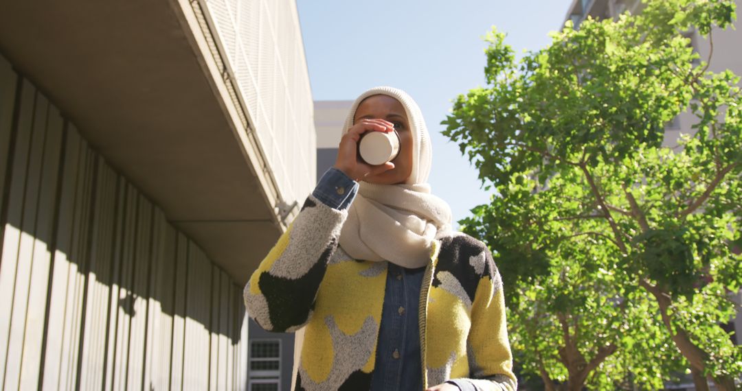 Young Woman in Hijab Enjoys Coffee Outdoors - Free Images, Stock Photos and Pictures on Pikwizard.com