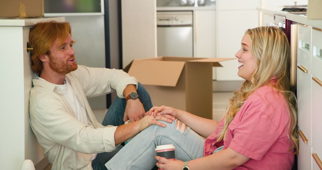 Happy Couple Enjoys Coffee During Move in New Kitchen