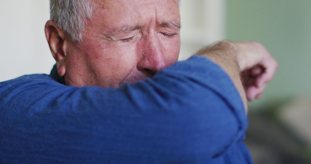 Elderly Man Sneezing into Elbow for Common Flu Prevention - Free Images, Stock Photos and Pictures on Pikwizard.com