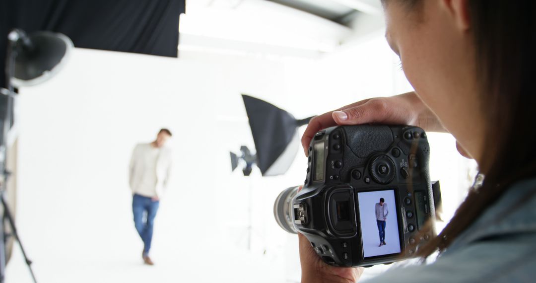 Photographer Capturing Male Model in Studio - Free Images, Stock Photos and Pictures on Pikwizard.com