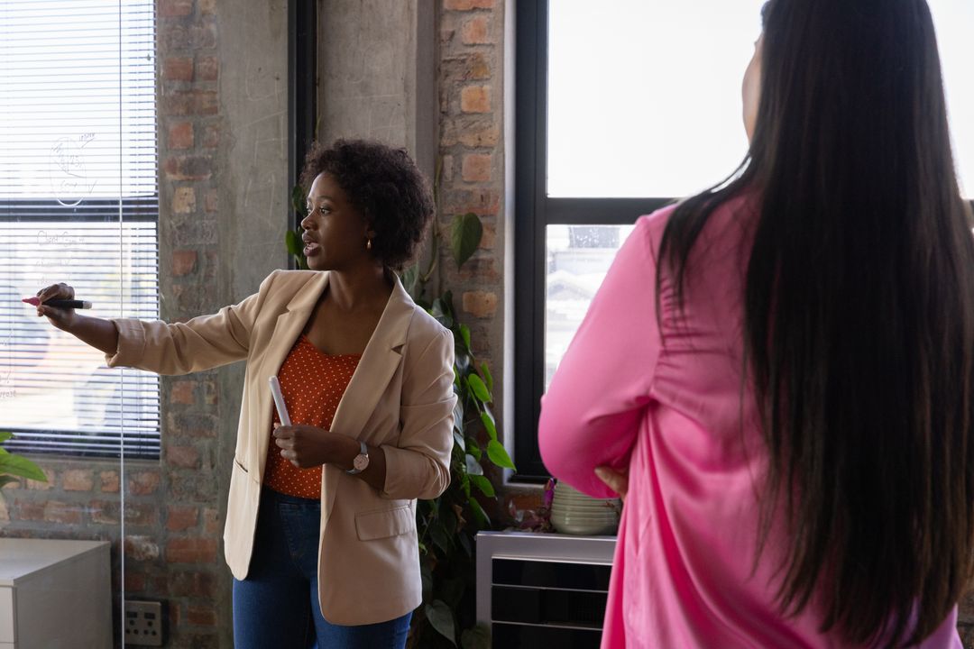 Coworkers Collaborating on Creative Project in Office