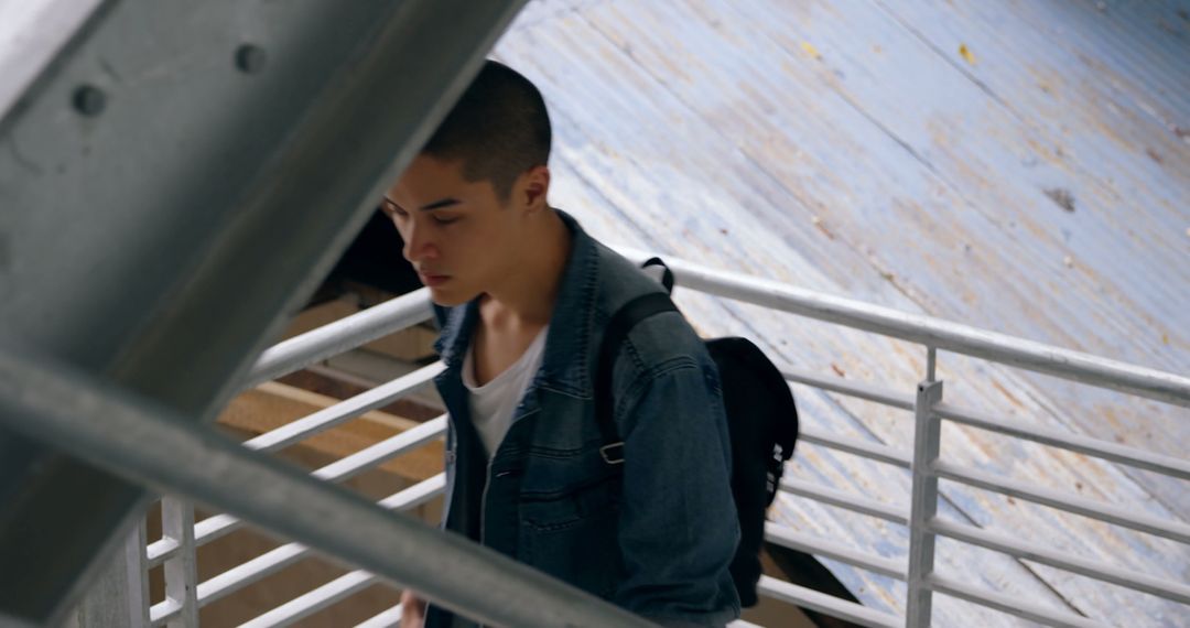 Young Man Descending Stairs in Casual Outfit for Day Out - Free Images, Stock Photos and Pictures on Pikwizard.com