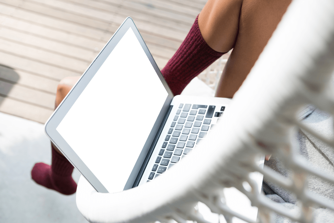 Laptop on Balcony Swing Chair with Red Socks Visible