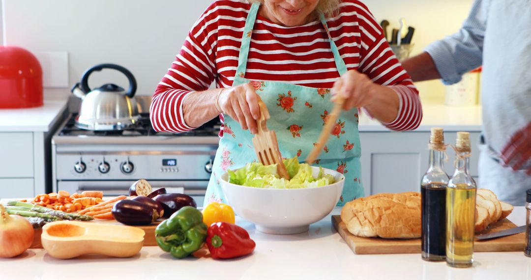 Senior Woman Making Fresh Salad in Home Kitchen - Free Images, Stock Photos and Pictures on Pikwizard.com