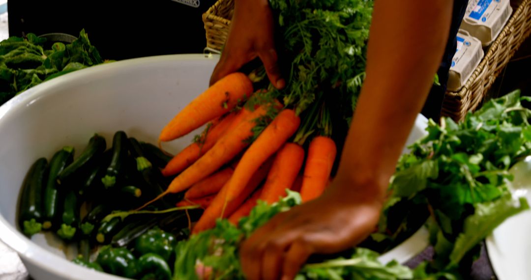 Person Selecting Fresh Carrots From Stall At Farmers Market - Free Images, Stock Photos and Pictures on Pikwizard.com