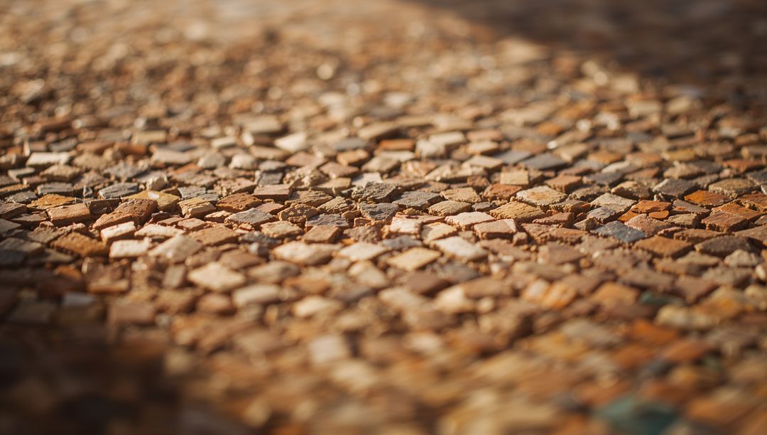 Sunlit Terracotta Mosaic Pavement with Worn Grout and Chipped Tiles, Rustic Courtyard Texture