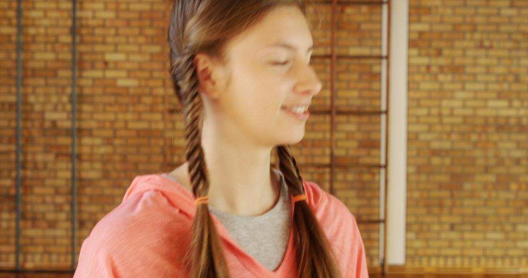 Teenage Girl With Braided Hair Smiling Indoors - Free Images, Stock Photos and Pictures on Pikwizard.com