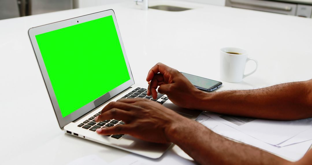 Person Typing on Laptop with Green Screen in Bright Office - Free Images, Stock Photos and Pictures on Pikwizard.com