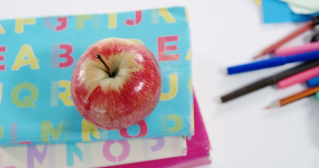 Red Apple on Colorful Books and Assorted School Supplies - Free Images, Stock Photos and Pictures on Pikwizard.com