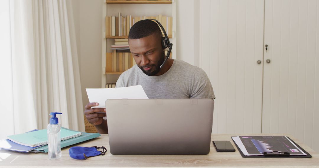 Young African American Man Working from Home with Headset and Laptop - Free Images, Stock Photos and Pictures on Pikwizard.com