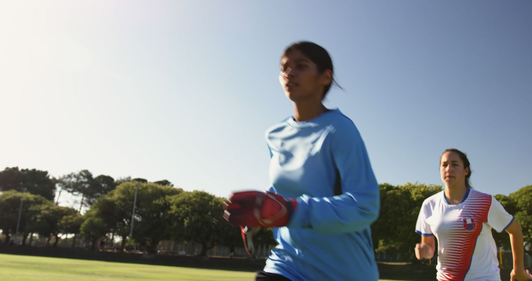 Female Soccer Players Training on Field Under Clear Sky - Free Images, Stock Photos and Pictures on Pikwizard.com