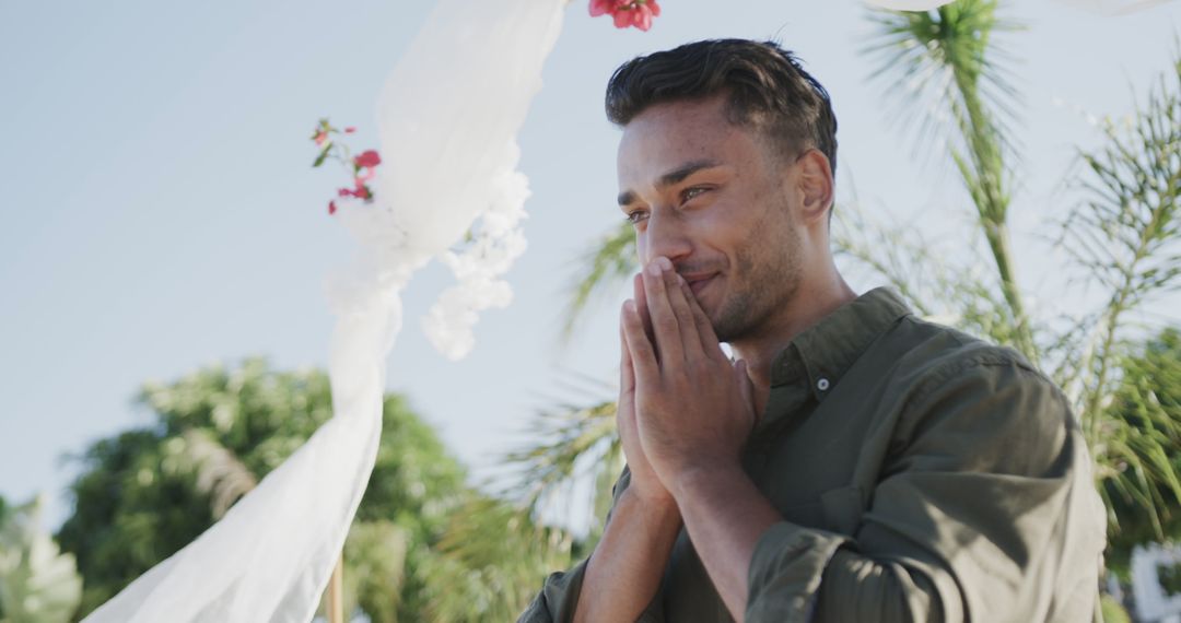 Emotional man enjoying special moment outdoors against palm trees - Free Images, Stock Photos and Pictures on Pikwizard.com