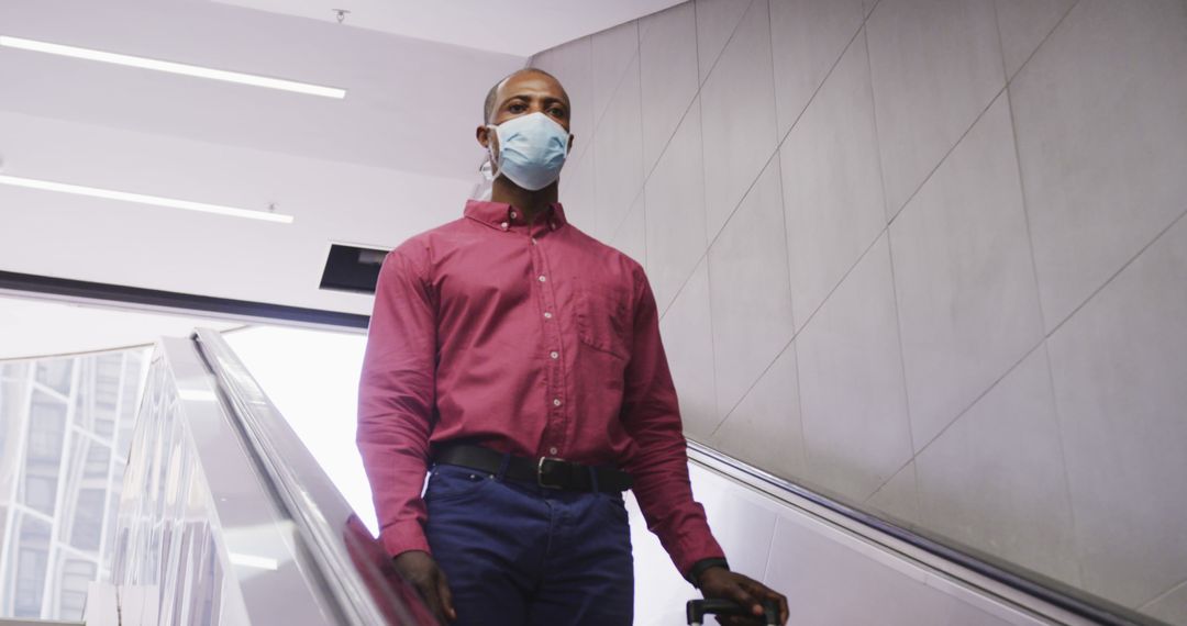 Businessman Wearing Face Mask Traveling on Escalator - Free Images, Stock Photos and Pictures on Pikwizard.com