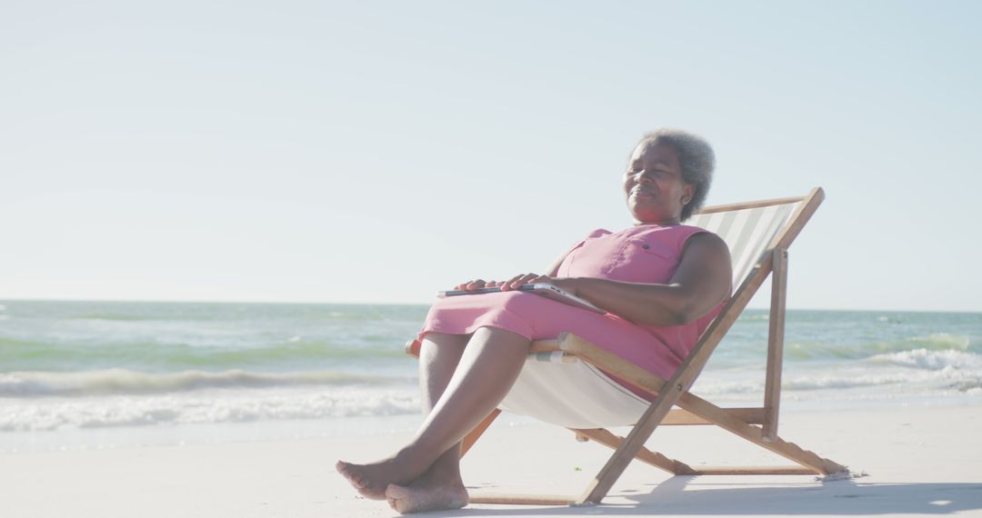 Senior Woman Relaxing on Beach in Deck Chair under Sunlight - Free Images, Stock Photos and Pictures on Pikwizard.com