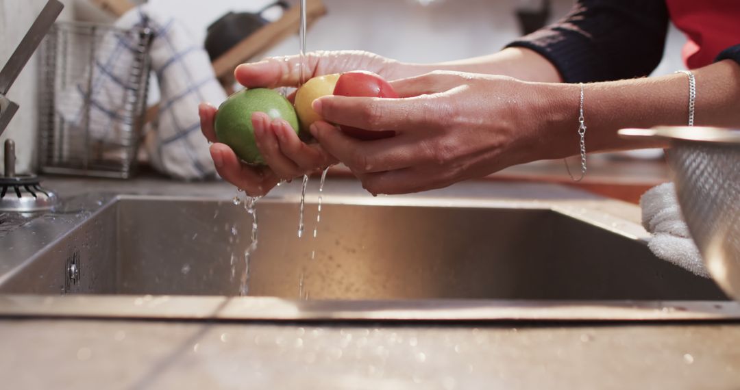 Washing Fresh Fruits Under Running Water in Kitchen Sink - Free Images, Stock Photos and Pictures on Pikwizard.com