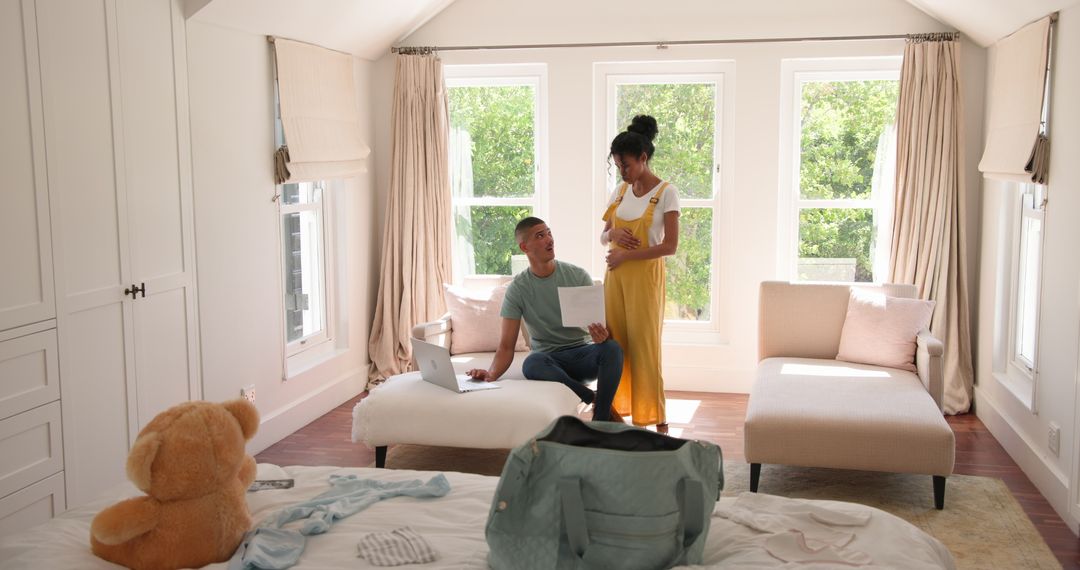 Couple Collaborating on Financial Plans in a Sunny Bedroom