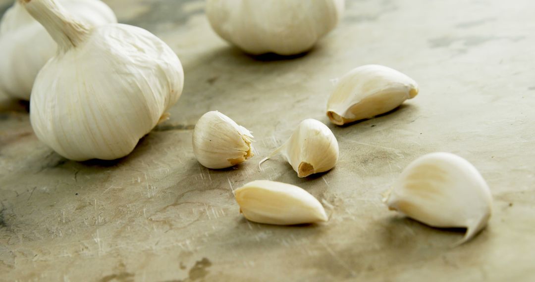 Fresh Garlic Bulbs and Cloves on Rustic Kitchen Counter - Free Images, Stock Photos and Pictures on Pikwizard.com