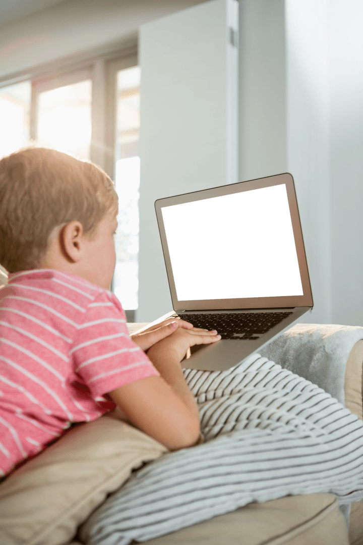 Boy Using Laptop on Cozy Sofa in Bright Living Room Interior
