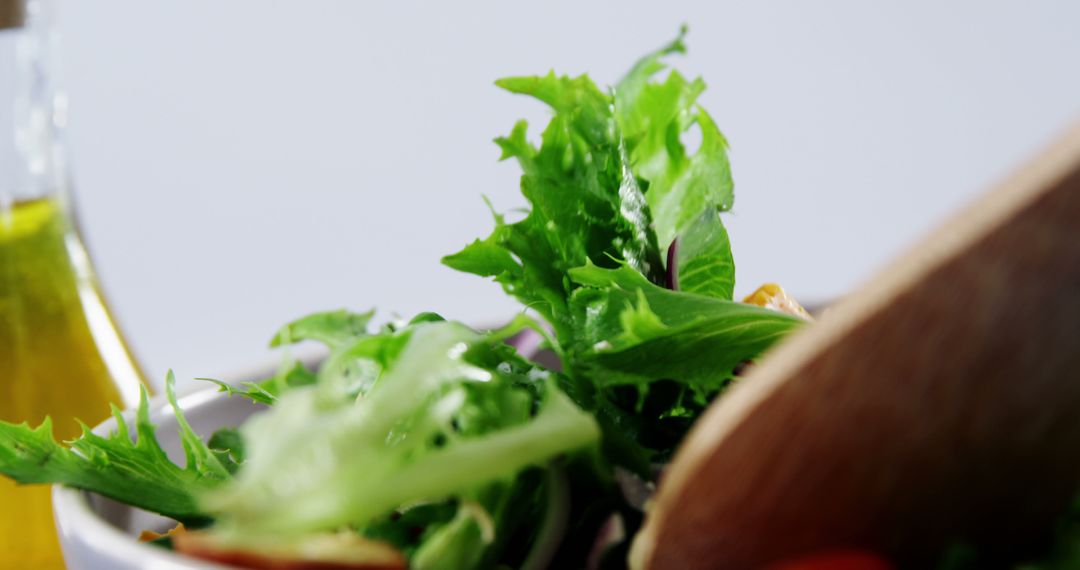 Close-up of Fresh Green Salad with Dressing Bottle - Free Images, Stock Photos and Pictures on Pikwizard.com