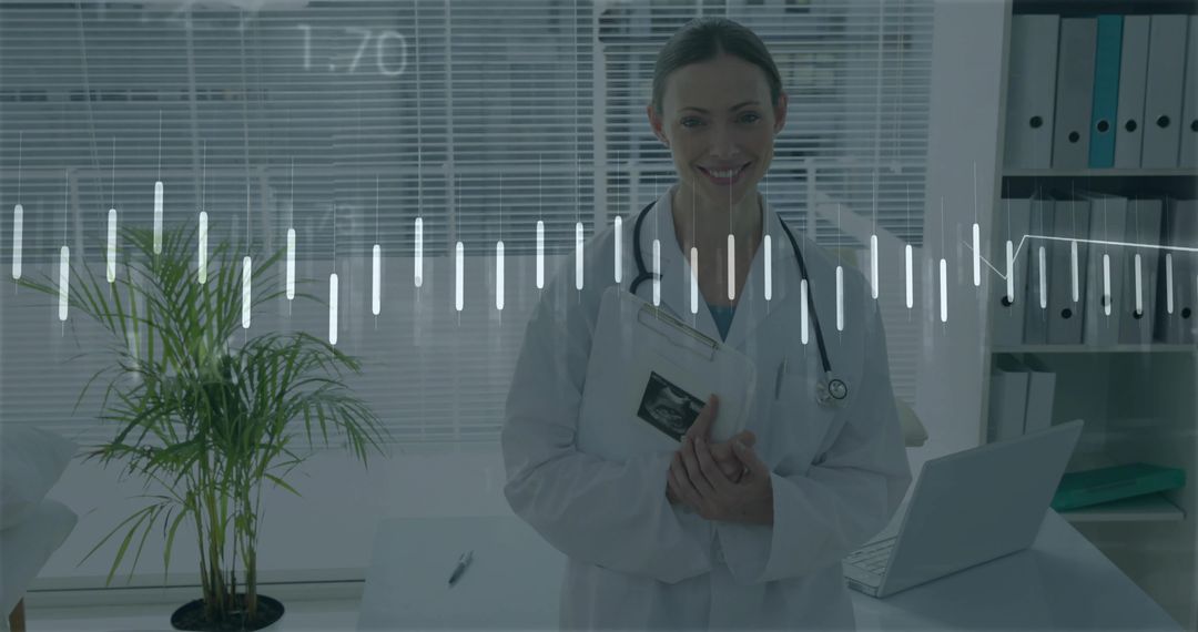 Smiling Female Obstetrician Holding Ultrasound Scan Wearing Stethoscope in Clinic Office