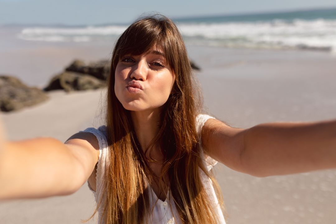 Young Woman Pouting for Selfie on Sunny Beach - Free Images, Stock Photos and Pictures on Pikwizard.com