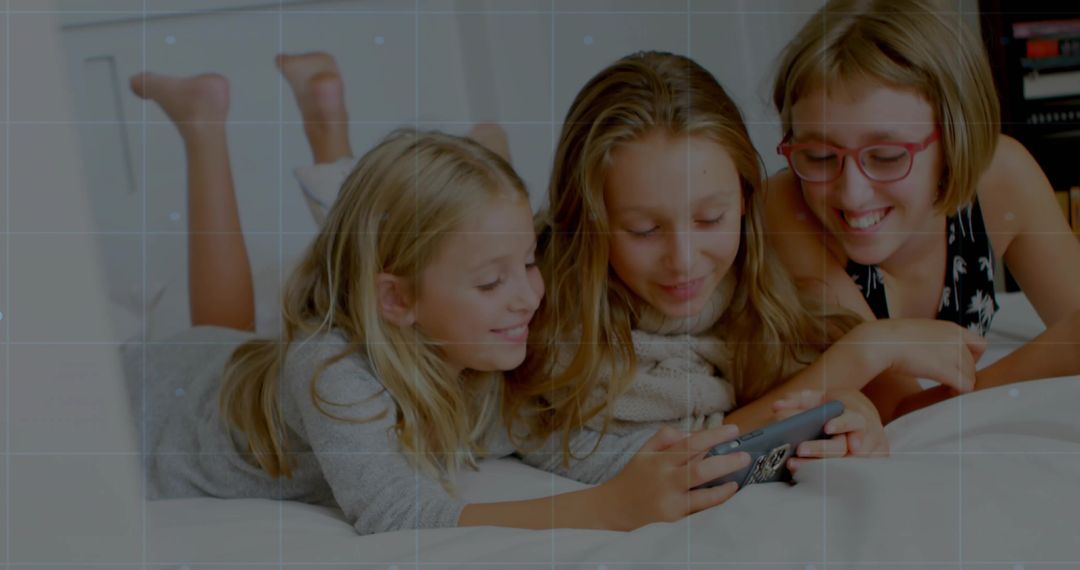 Three Siblings Watching Smartphone on Bed Smiling