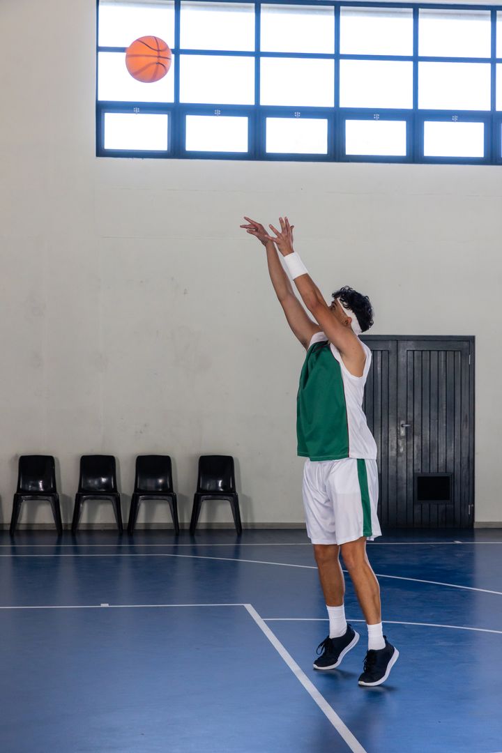 Male Basketball Player Shooting in Gym with Natural Light
