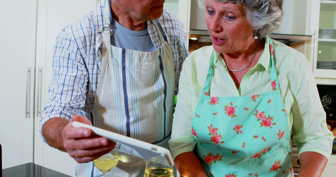 Senior Couple Cooking Together in Kitchen with Digital Tablet - Free Images, Stock Photos and Pictures on Pikwizard.com