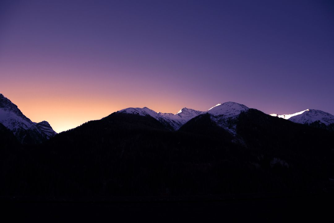 Snow-Capped Mountains at Dusk with Vibrant Horizon - Free Images, Stock Photos and Pictures on Pikwizard.com