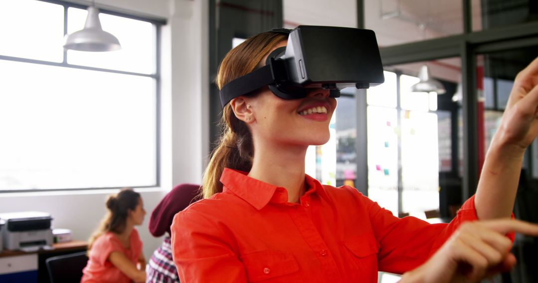 Young Woman Enjoying Virtual Reality Experience in Modern Office - Free Images, Stock Photos and Pictures on Pikwizard.com