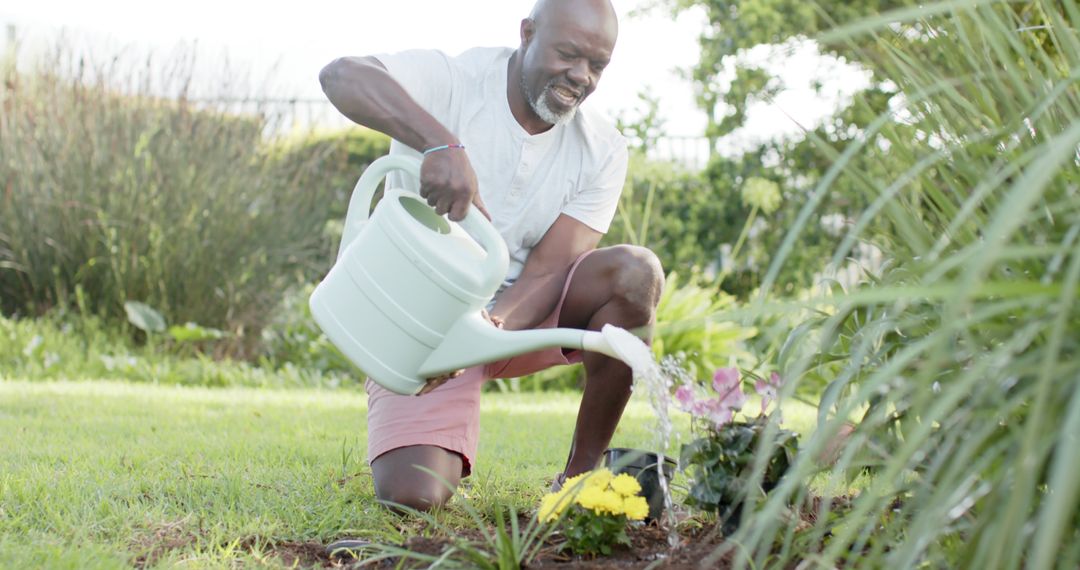 Happy Senior Man Watering Plants in Garden for Relaxation - Free Images, Stock Photos and Pictures on Pikwizard.com