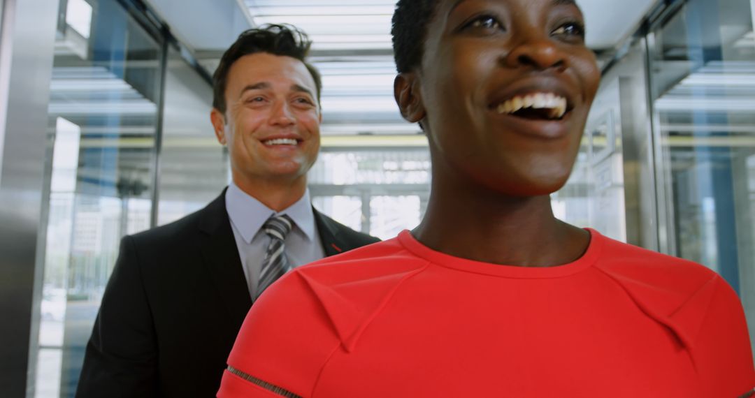 Excited Businesspeople Departing Elevator Smiling - Free Images, Stock Photos and Pictures on Pikwizard.com