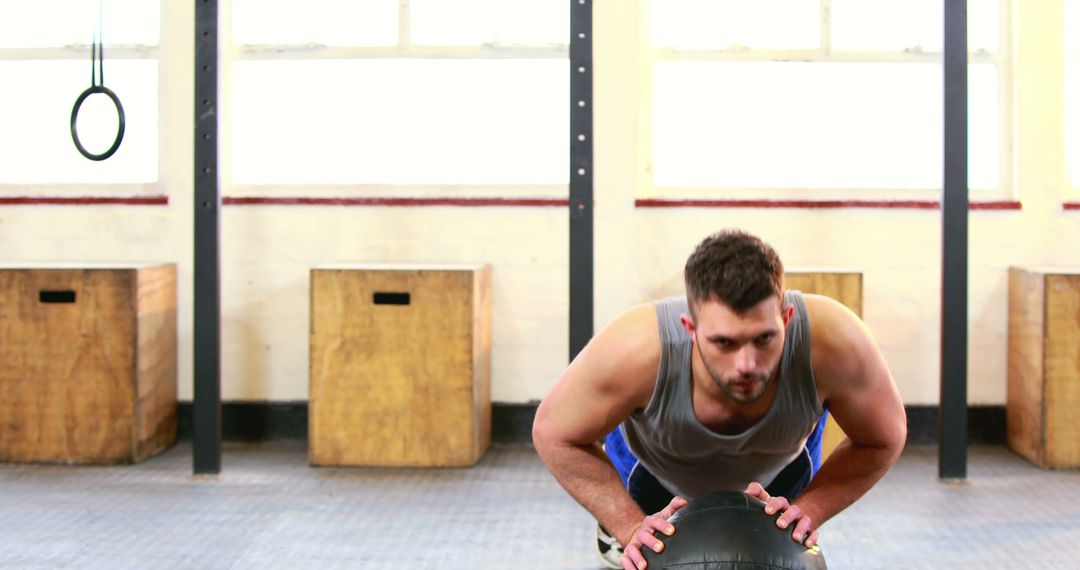 Man Performing Push-ups on Medicine Ball in Gym - Free Images, Stock Photos and Pictures on Pikwizard.com