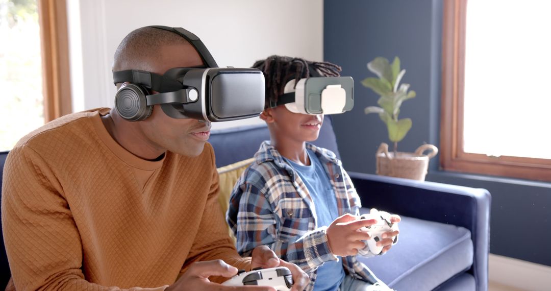 Father and Son Enjoying Virtual Reality Gaming Together on Sofa - Free Images, Stock Photos and Pictures on Pikwizard.com