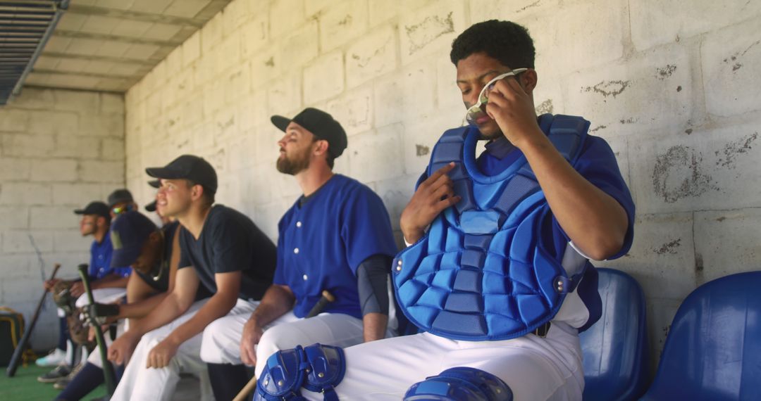 Baseball Team Relaxing in Dugout Before Game - Free Images, Stock Photos and Pictures on Pikwizard.com