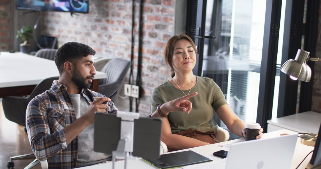 Asian Professionals Collaborating in a Modern Workspace