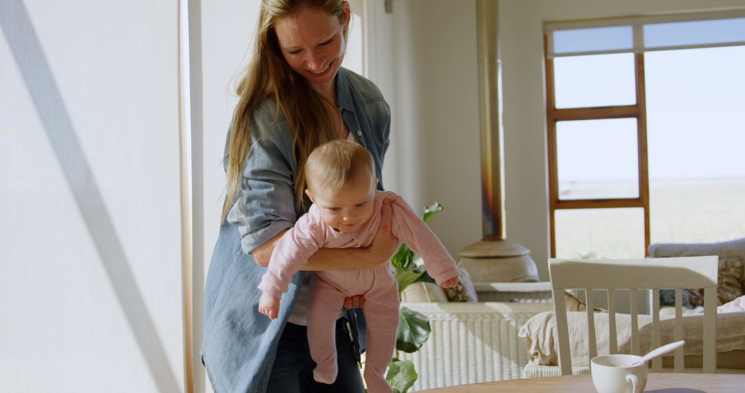 Mother Cradling Baby in Sunlit Living Room - Free Images, Stock Photos and Pictures on Pikwizard.com