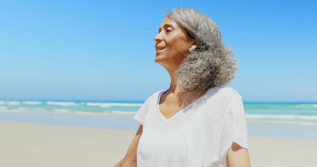 Senior Woman Enjoying Serenity on Sunny Beach