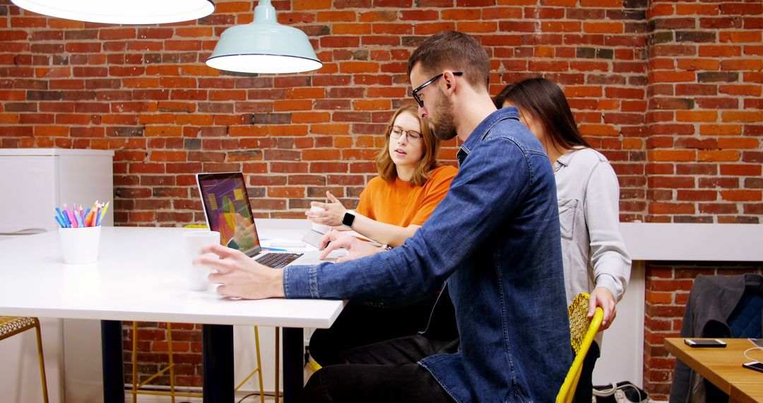 Team of young professionals brainstorming in modern office - Free Images, Stock Photos and Pictures on Pikwizard.com