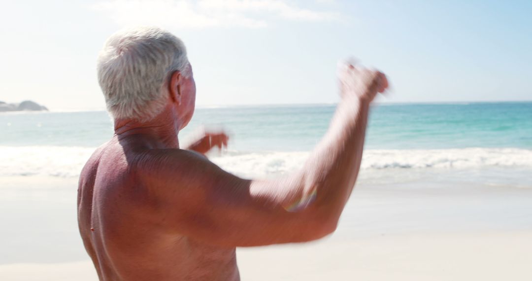 Senior Man Enjoying a Sunny Day on the Beach - Free Images, Stock Photos and Pictures on Pikwizard.com