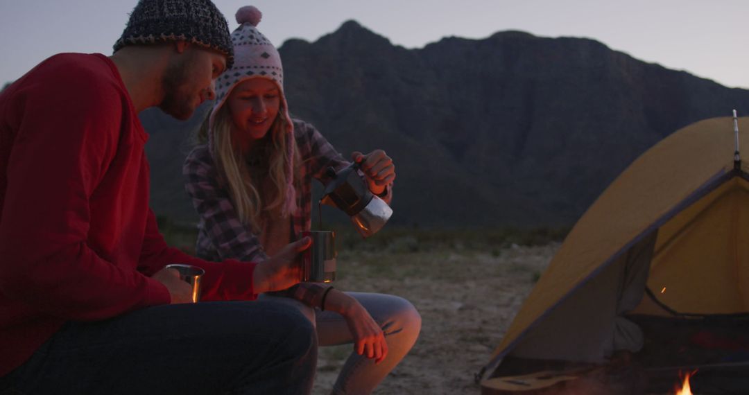 Couple Enjoying Evening Coffee by Campsite in Mountains - Free Images, Stock Photos and Pictures on Pikwizard.com